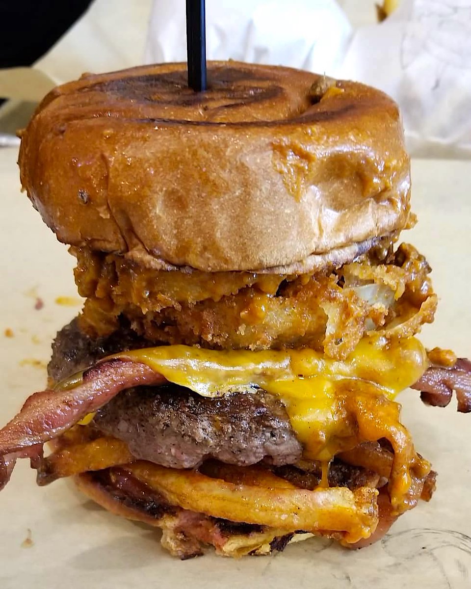 GrillEmAll's tweet photo. Our (sorta) secret menu item is here for the slammin’ everyday! @ZakkWyldeBLS's Berzerker Burg: Blackened half pound patty, onion rings, white truffle pomme frites, chipotle ketchup, cheddar &amp; thick cut bacon all smothered in our chili! #tBLSt #SDMF!!! https://t.co/3TpujxArsT