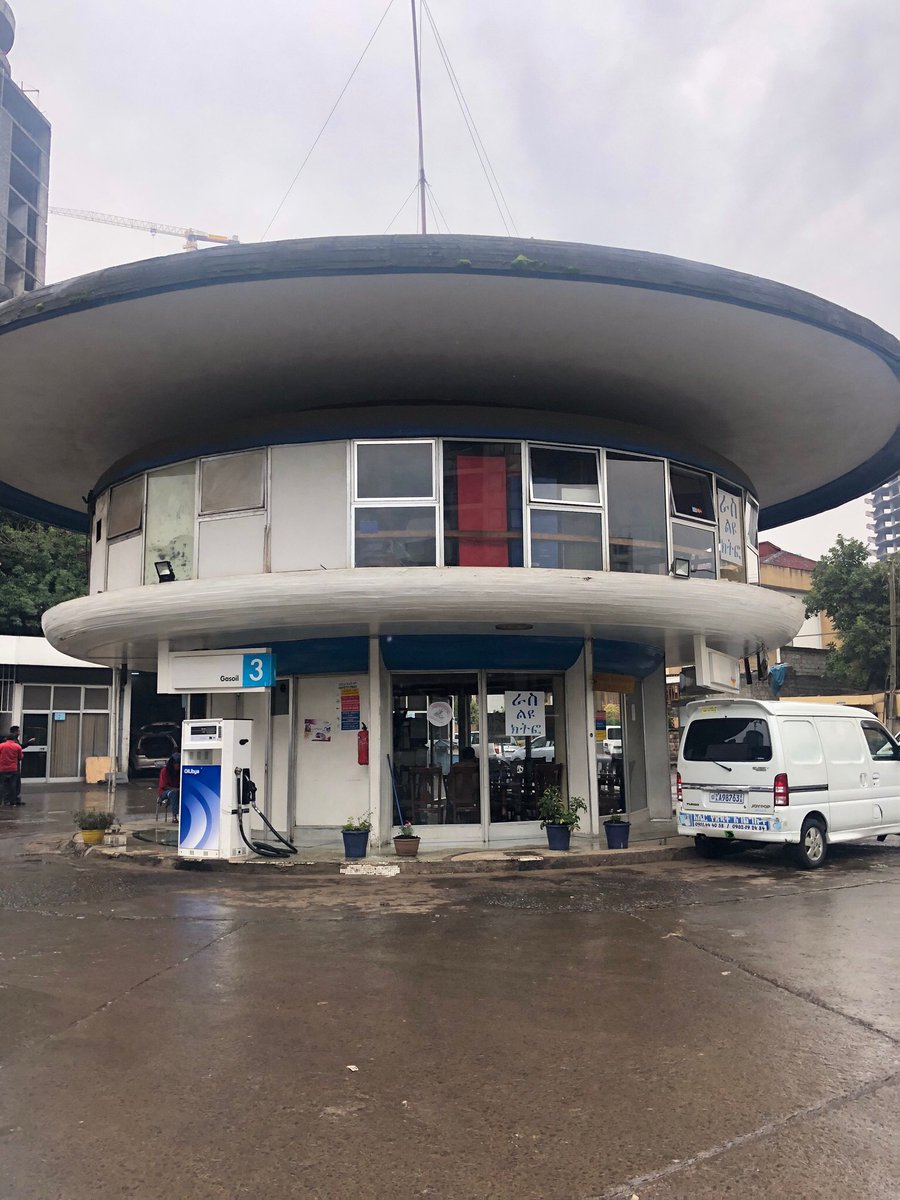 MediaETHIOPIA's tweet photo. Another landmark in Addis that is aging well is the Ras Gas Station near the National Theatre. Designed by the legendary  Arturo Mezzedimi himself who also designed the Municipality &amp; ECA buildings in #Ethiopia, this round building has stood the test of time. #BeautifulAddis. https://t.co/m3Wioowj6G