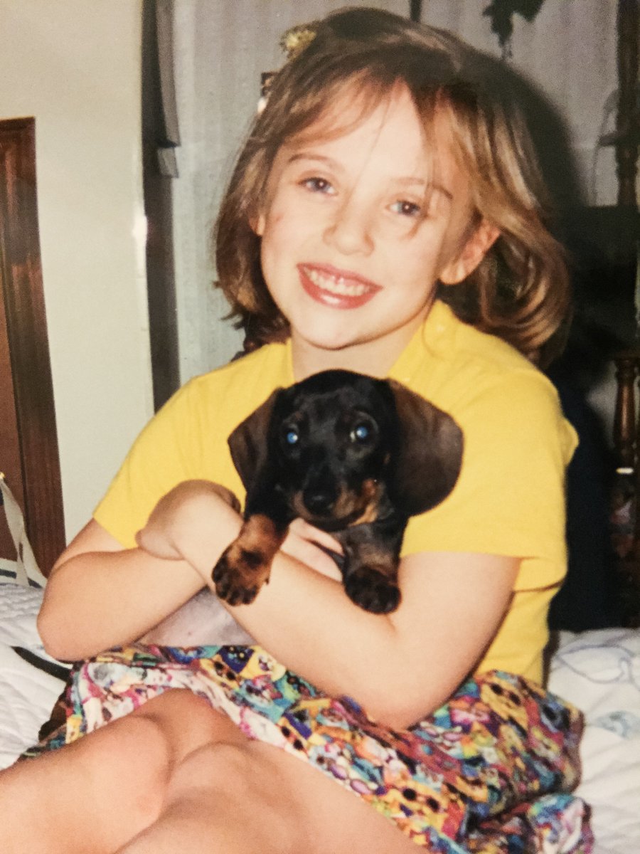 kmkmedia's tweet photo. When KMK opened it's doors in 1998, KMK's Maegan Ratts was only 5 years old! Here she is pictured with her first dachshund, Mazie. 🐾 Happy 1 year workiversary, Maegan! #KMKTurns20 https://t.co/D6b005mi09