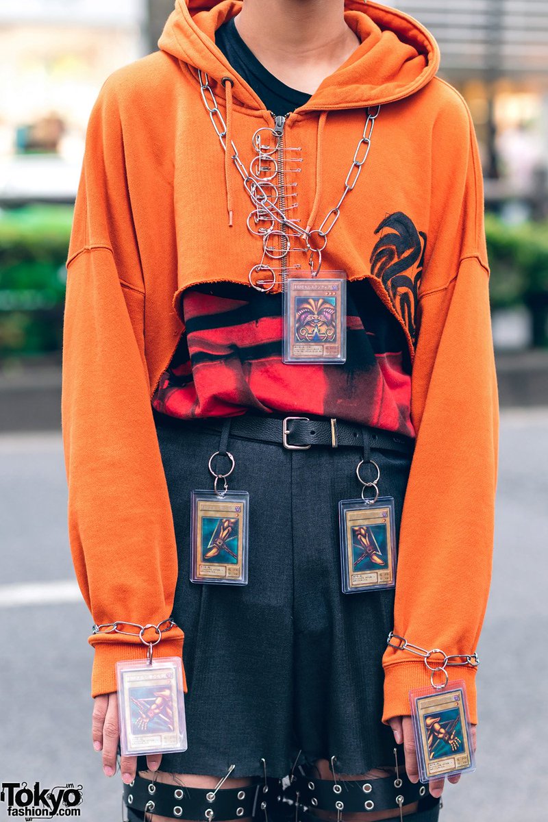 TokyoFashion's tweet photo. Tokyo high school student Makoto on the street in Harajuku wearing a remake style with Yu-Gi-Oh! Cards as accessories, a remake cropped painted hoodie, cutout pants &amp; Dr. Martens shoes #原宿 https://t.co/7tiiQsAJue https://t.co/jocXSbEJbd