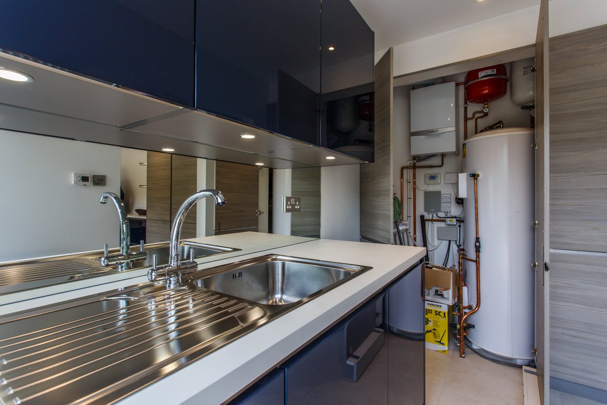 ColliersUK's tweet photo. A brilliant way to hide unsightly pipework, boilers &amp; electrical boxes - creating custom units helps to hide the fixtures away, also providing add. storage. The tall doors creates a sleek feel in this utility space. 
#Worthing #Kitchens #GermanKitchens #SussexKitchens #Utility https://t.co/3ZvfgoZLQ3