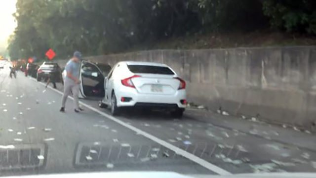 ajc's tweet photo. WATCH: Drivers grab cash after armored truck spills contents on I-285 https://t.co/JYeVLa795y https://t.co/g1HqZxWbfp