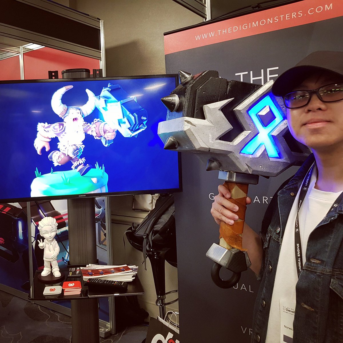 DigiMonsterBoss's tweet photo. SURPRISE!!!! The concept artist with his creation brought to life. Safe to say that @DanzioChan wasn't expecting this. :D Swing by TheDigiMonsters stand to strike a pose with the hammer. #DigiLabs #Hexray #develop2019 #developbrighton #NorwichUniversity #conceptartist #gamedev https://t.co/Ll2PBR6uGM