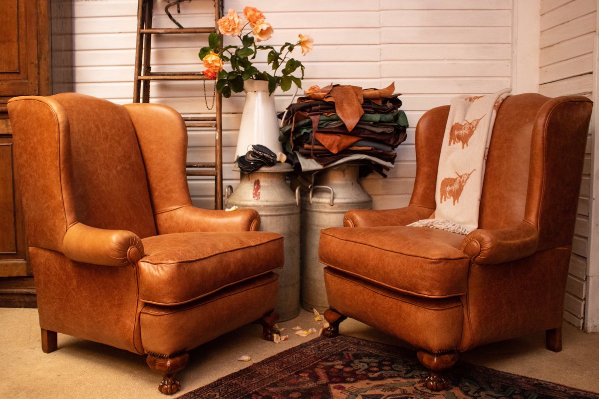 Timeless classic Edwardian Wing Back Armchairs on walnut ball and claw feet traditionally reupholstered with horse hair, cotton lintas and covered with Scottish hide.