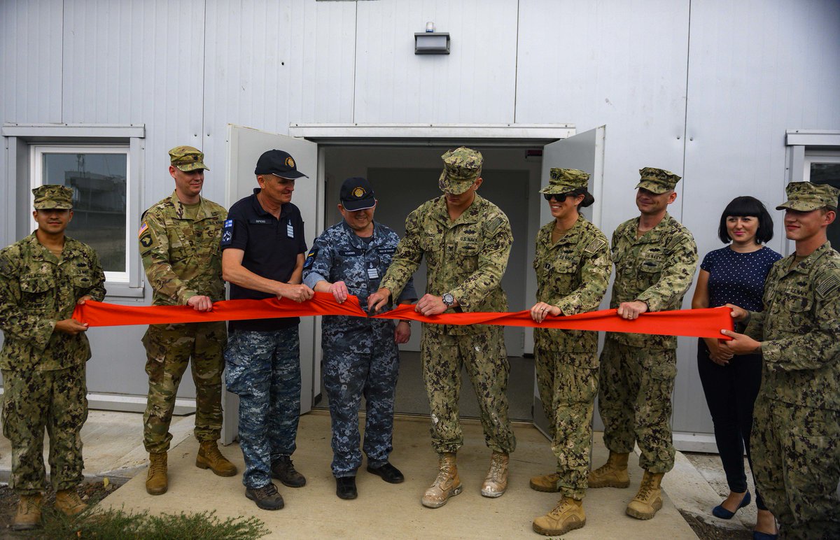 USNavyEurope's tweet photo. Sailors assigned to Naval Mobile Construction Battalion 133 participate in a ribbon cutting ceremony delivering a maritime operations center to the Ukrainian Navy during @ExSeaBreeze 2019 in Ochakiv, Ukraine 🇺🇦. #NMCB133 #SEABEES https://t.co/izAyBQNTnv