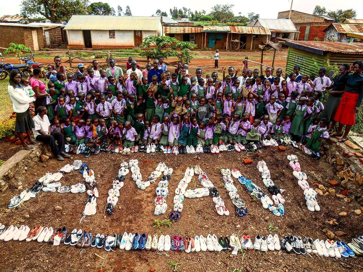 KidsforPeace's tweet photo. It's #ThrowbackThursday and we love remembering the time we partnered with @SHOEBACCA to bring shoes to the children at our Kids for Peace School of Kenya. The kids loved spelling out AMANI (PEACE in Swahili) with the shoes to show their gratitude! #KidsForPeace #KindnessMatters https://t.co/gZQWWOBmLT