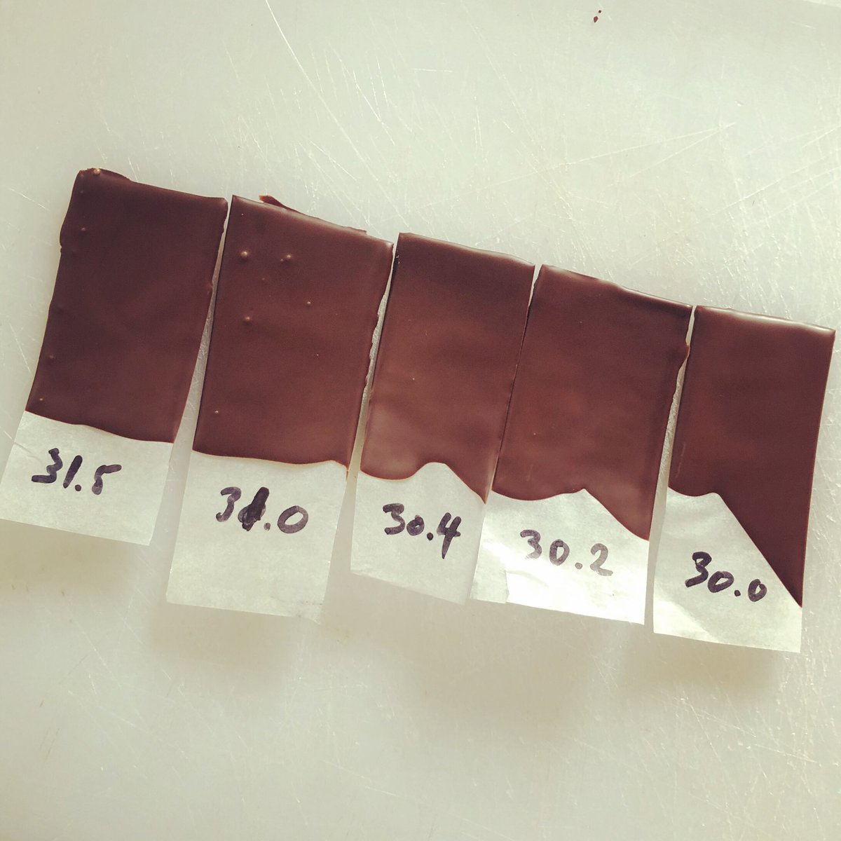 In our world, crystallisation is key to shiny, snappy and beautiful chocolate.  And so we constantly check... the old fashion way! In this case 30c is the best result. This can change according to the chocolate, room temperature, atmospheric humidity
#chocolate #science #crystals