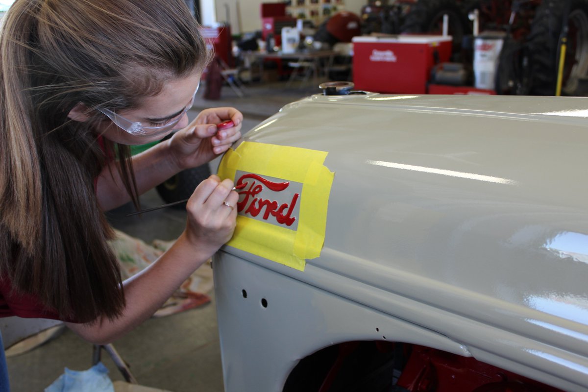 NevadaFFA's tweet photo. Areianna doing some awesome detail painting on Ford tractor this morning #details #quality #skills @IowaStateFair #SupervisedAgExperience #NevadaCubPride https://t.co/LTp63WUFbk