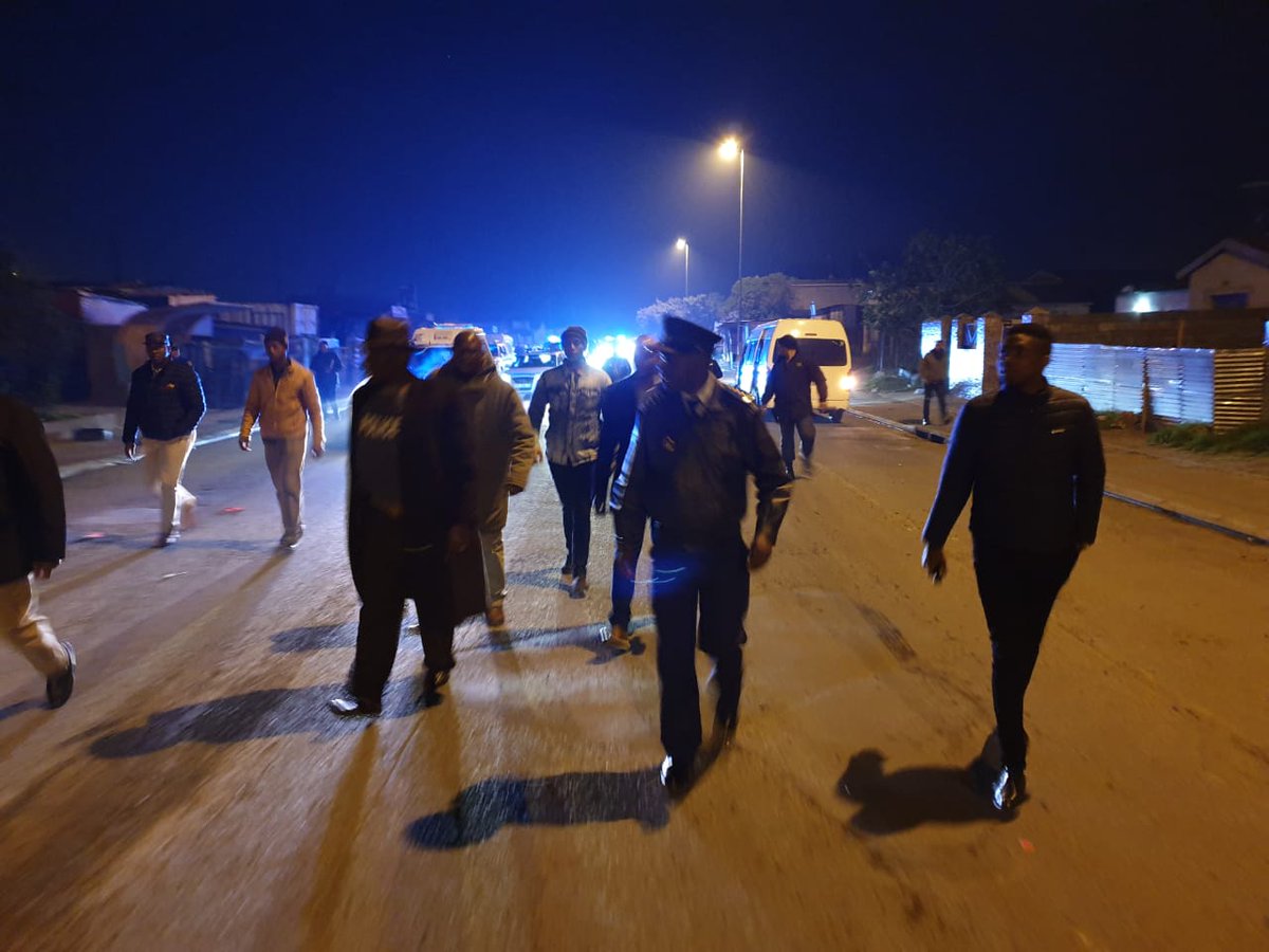 Police vehicles patrol a Cape Flats community following gang-related shootings
