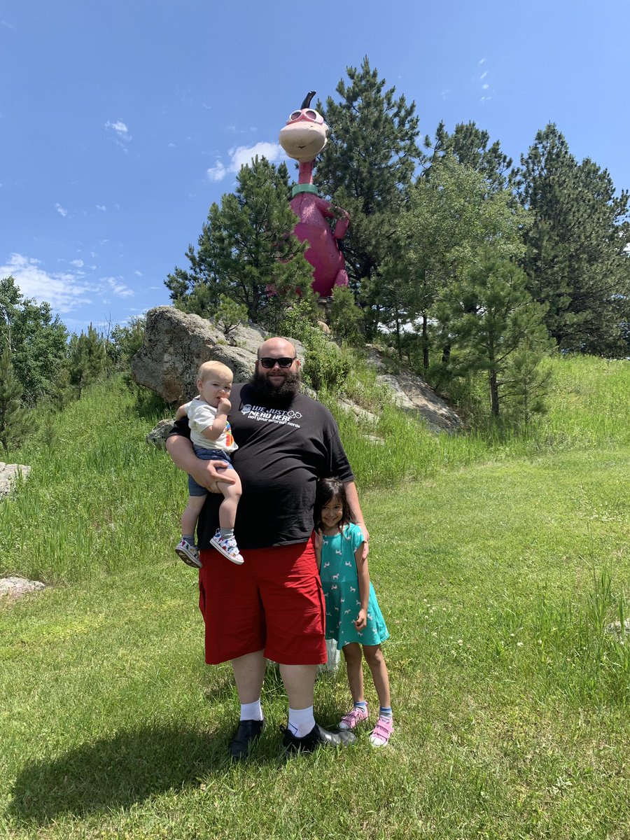 JoshuaTracey85's tweet photo. Day 2 and the giant statues of cartoon characters continue! #Flintstones #BedrockVillage in Custer SD may be gone, but giant Dino remains! So glad I got to have a pic with my kids here. #HelloFromSD #Vacation #ChildhoodRevisited https://t.co/c61Fg0Wpc2
