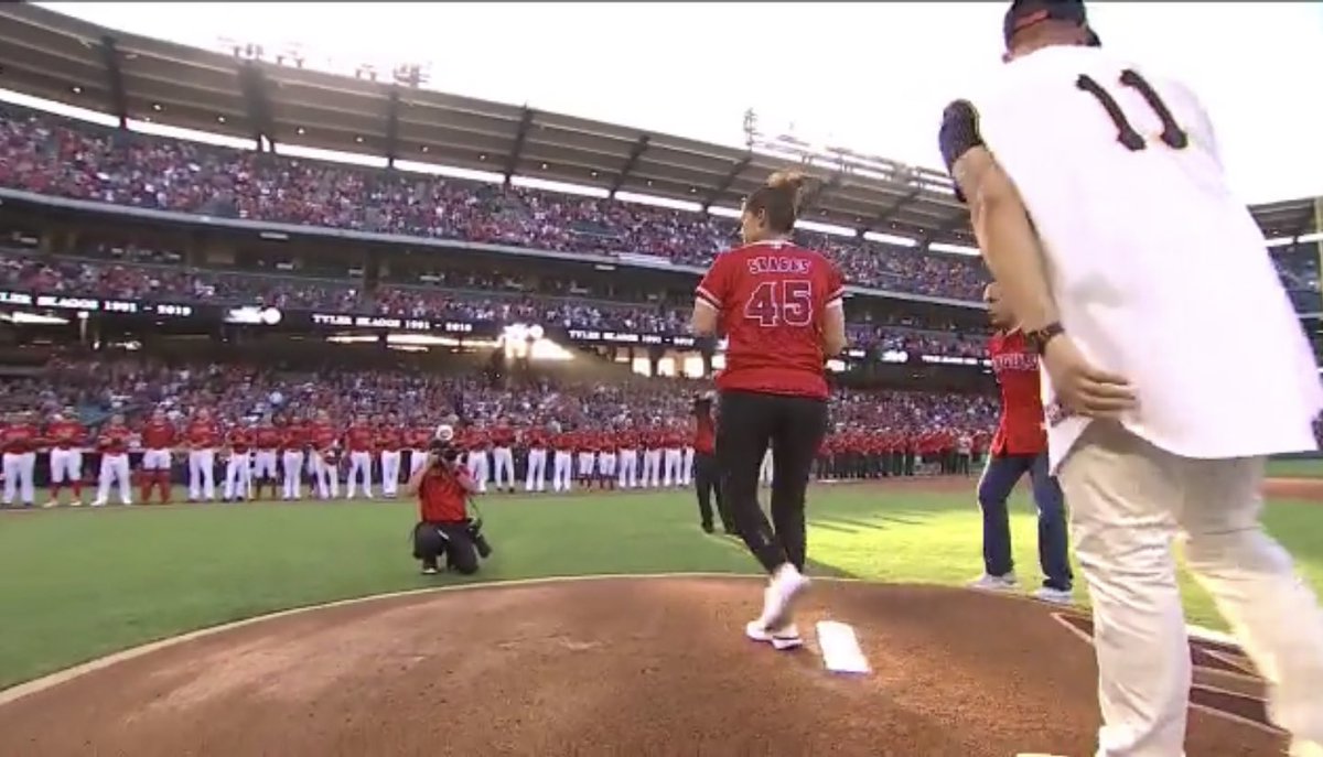 HaloHangout's tweet photo. Debbie Skaggs @TylerSkaggs37 on the mound throwing the first pitch to Andrew Heaney @Heandog8 Very emotional moment. #45We’reNasty @calfladave22 https://t.co/vwYAbBe9Jv