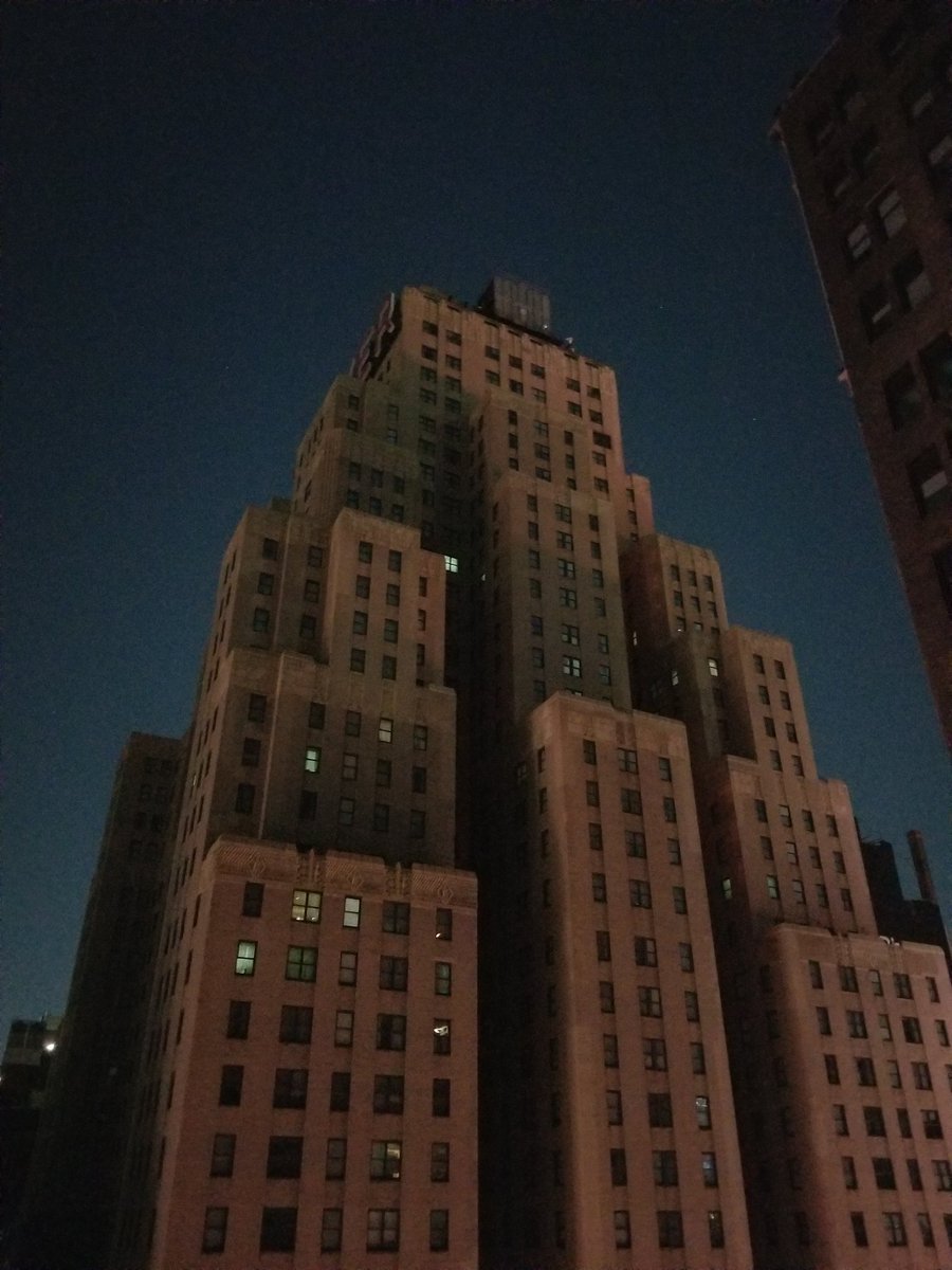 Only cell phones and flashlights illuminating the New Yorker  building tonight #blackout #ManhattanBlackout