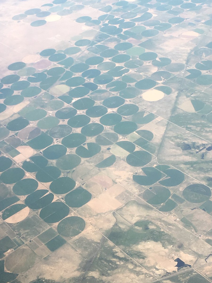 MrsMTLC's tweet photo. Such fun flying over the Midwest and seeing this! Farmland in these amazing shapes (my kids were eager for me to take pics for my ‘kids’)! Why the circles -  is what I wonder!#rpsummer19 #engagemath https://t.co/qQSdlIooVO