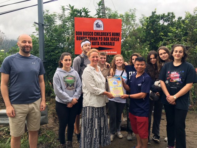 Worth students and staff on the Borneo service expedition trip at the Don Bosco’s Children’s Home with a new school sign donated by the School.