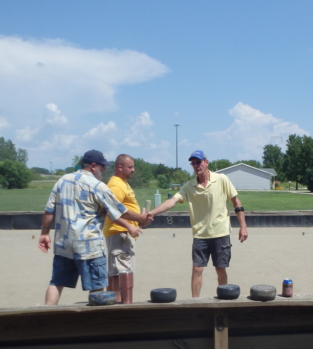 Marie1Culpepper's tweet photo. Bolders shake hands before a game of rolle bolle at the Rolle Bolle World Tournament in Annawan, IL. The gentleman on the left, Roy De Pauw, is one of two rolle bolle makers in the country. @UI_HPG @UIGradCollege #rollebolle #IowaValleyRCD https://t.co/coBxHmHrBT