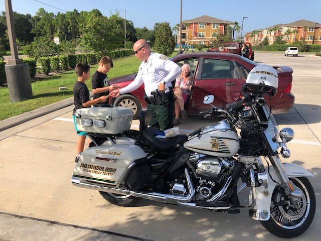 HCSOSheriff's tweet photo. District III Motor Deputy Kevin Baker ran into two children who were fascinated with his motorcycle.  Deputy Baker took the time to show them his bike, &amp; tell them a little about his job. He gave them stickers prior to leaving, brightening their day for sure! #teamhcso https://t.co/5D8D1i9cBx
