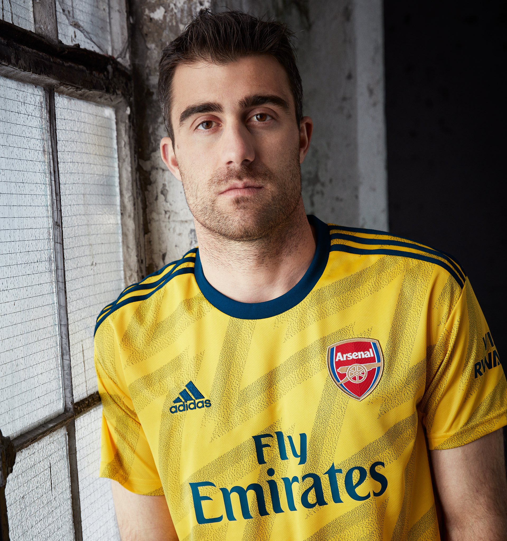 Modern Arsenal players in the 'bruised banana' Adidas kit will