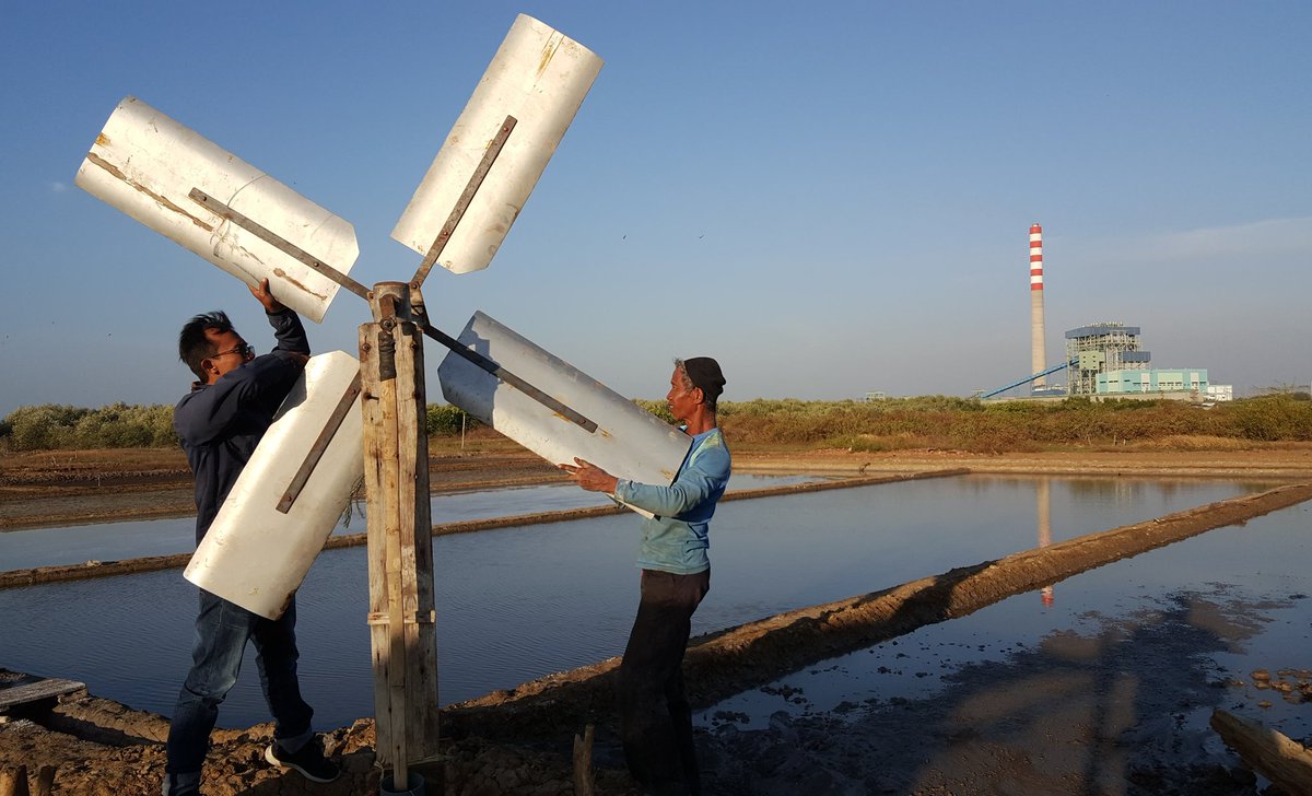 Surahman memasang kincir angin untuk memompa air laut agar mengairi tambak garamnya, tanpa listrik. Di belakangnya, PLTU Cirebon 660 MW, dan akan ditambah 1.000 MW.

Energi bersih, energi rakyat.