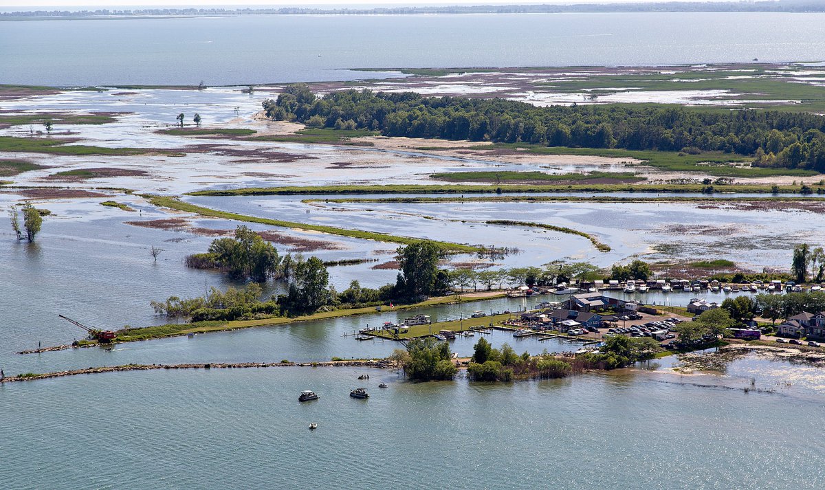 EXPbthompson's tweet photo. High #water levels are impacting much of the Lake Erie shoreline in southern Ontario, threatening some cottages and resulting in the significant loss of #beach areas. This view shows the #marina at west end of Turkey Point. #aerialphotography @TheExpositor https://t.co/R7NylUOnt3