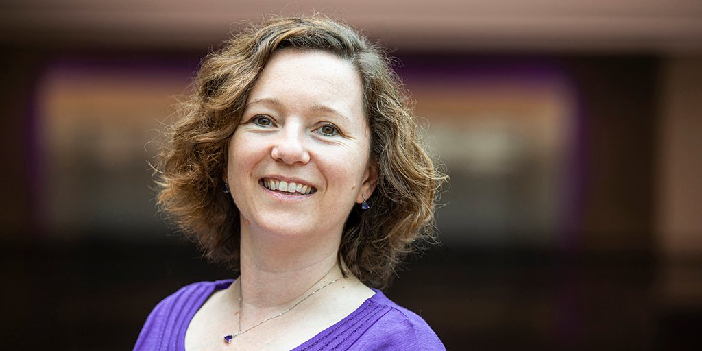 Woman wearing purple shirt smiling