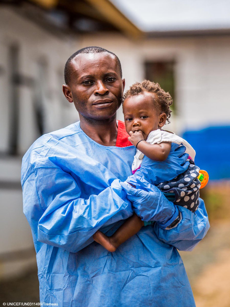 A UNICEF-supported carer holds a child - whose mother was infected with Ebola in DR Congo.