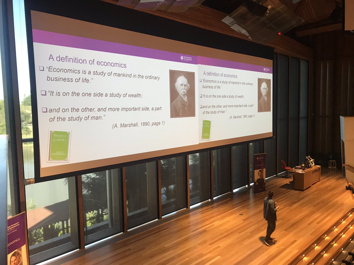 QETAinc's tweet photo. Dr Alexandros Karakostas introduces students to Alfred Marshall’s definition of economics #studenteconomicsday #economics @UQ_News #universityofqueensland #schoolofeconomics https://t.co/J4vtApnQJG