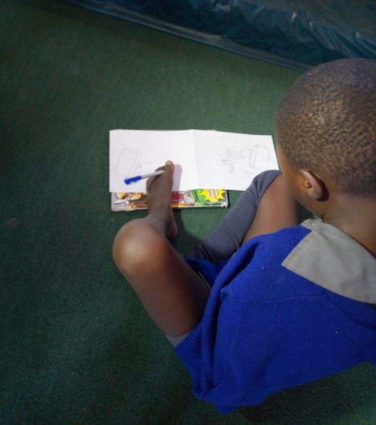 oxgnpr's tweet photo. Tapiwa one of the students at Jairos Jiri writing down his name using his legs. Disability does not mean inability. @OldMutualZW #NelsonMandelaDay https://t.co/7WPq5YmxnY