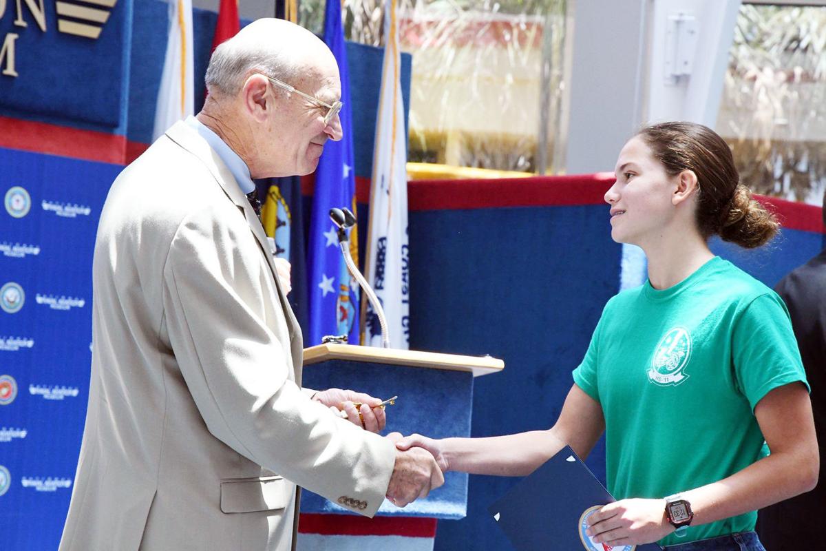 HudsonISD's tweet photo. Hudson High School Freshman CULLEN MERRELL, shakes the hand of retired Lt. Gen. Duane Thiessen as he awards her the AXP of the Week Award during the National Naval Flight Academy five-day deployment this summer. @buzzhhs @buzzhms @buzzbonner @buzzpeavy @#buzzhisd https://t.co/d4g9OHjni8