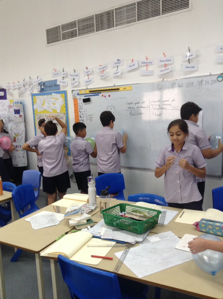 Year6_SBS's tweet photo. Finding out what objects are good at giving and taking electrons. Now we know why the school slide makes our hair stand on end! #sbsscience https://t.co/ad3KjcklGR