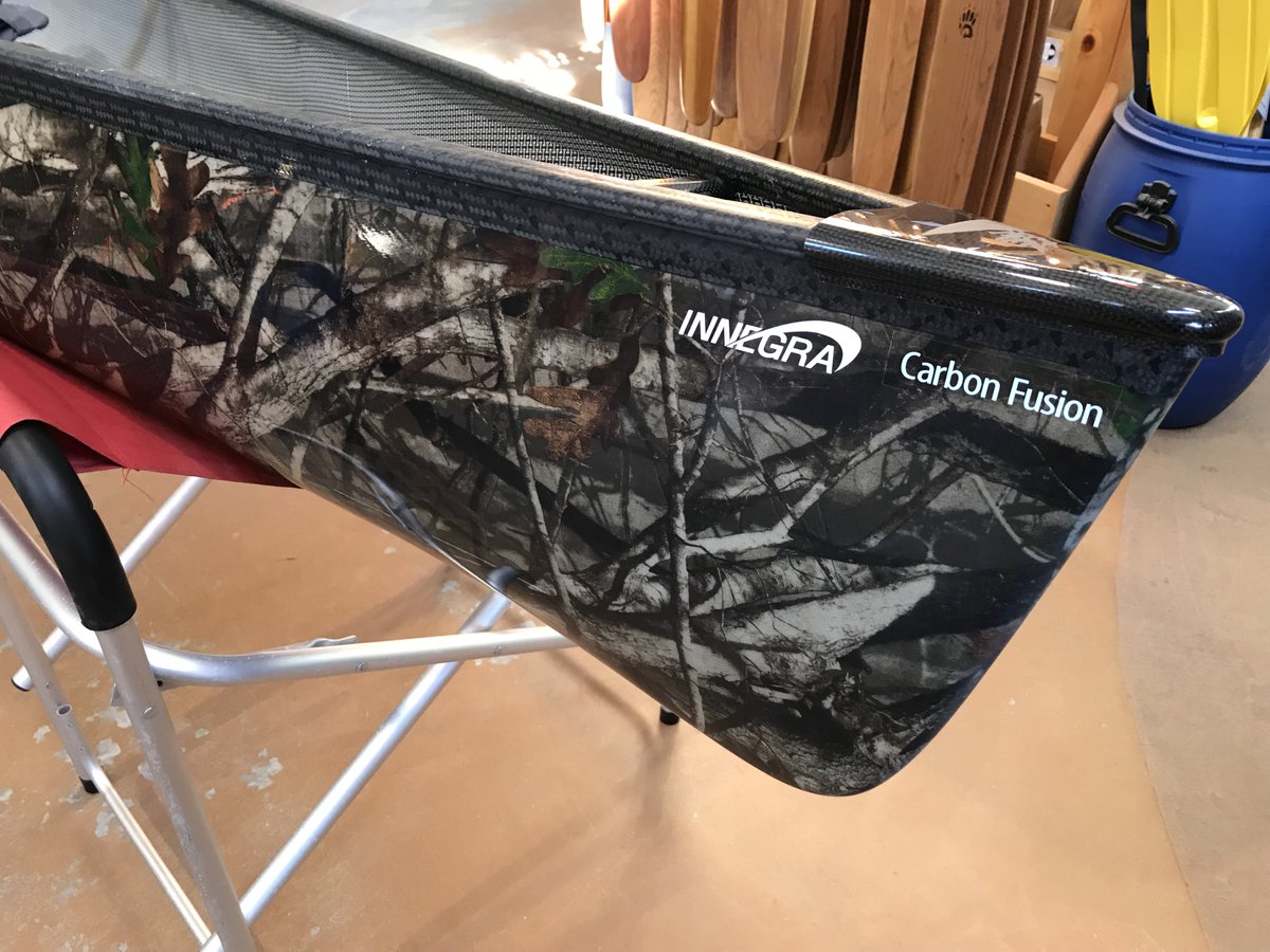 Swift_Canoe's tweet photo. New boats are starting to trickle in as we get closer to spring. Here's a real beauty that just arrived for a customer with a 'Hardwoods' pattern in lightweight Carbon Fusion. Just add nature. #getoutside #carbonfiber #Packboat https://t.co/wP73nDXWlu
