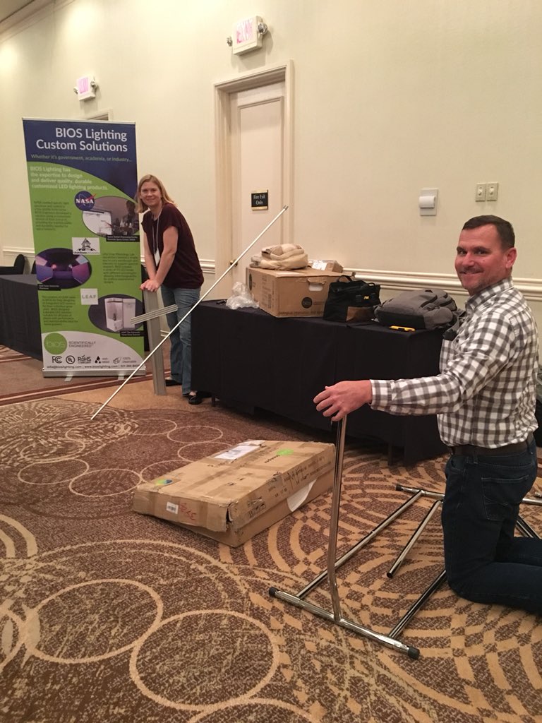 BIOSLIGHTINGLED's tweet photo. As committee secretary, Neil discusses last minute arrangements for #NCERA 101 and gets busy setting up the #bioslighting booth with Rebecca. What #photobiology topics do you want to know more about? #ncstate #indoorfarming #verticalfarming https://t.co/GKV6AaUTCm