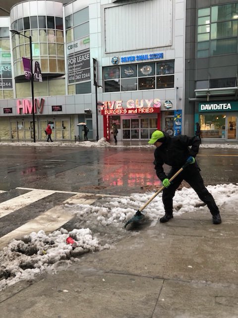 DowntownYonge's tweet photo. Our #CleanStreetsTeam is out clearing storm drains to reduce puddles & floods in the area! #YongeLove #YongeCleans #icestorm #TorontoIceStorm https://t.co/rGoZNXFoch