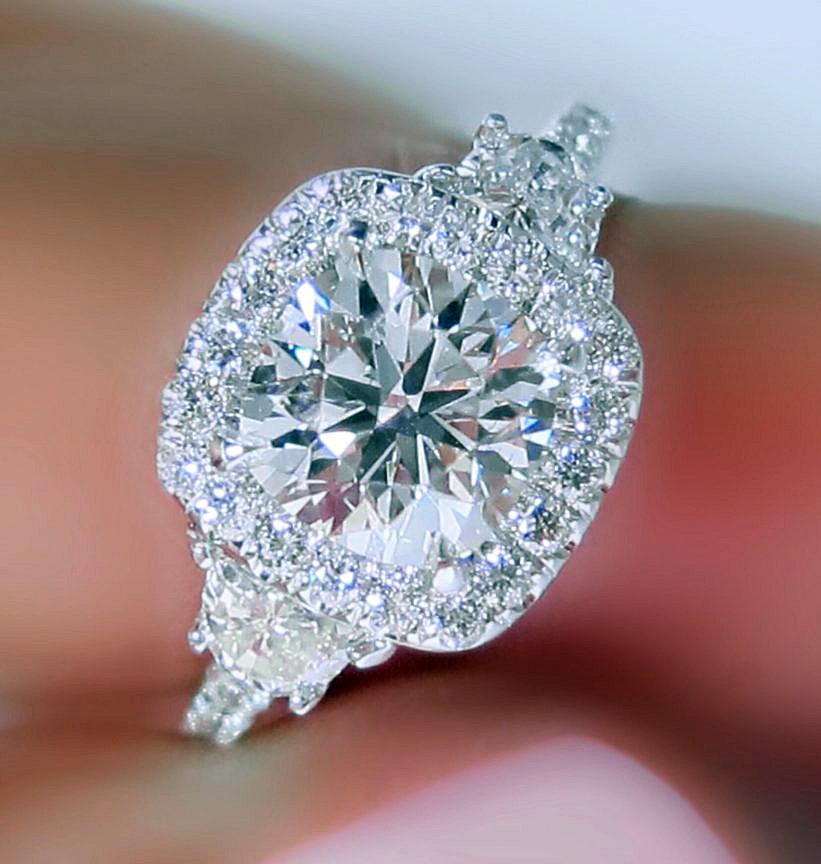 Halo Style White Three Stone Engagement Ring unusualengagementringsreview.com #white #three #stone #halo #style #round #diamond #engagementring #engagement #ring #weddingring #wedding