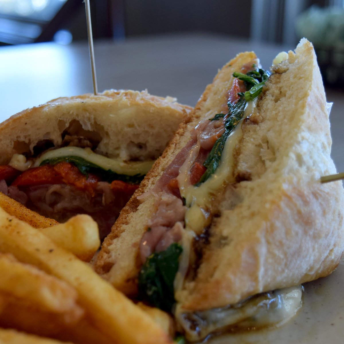 Did you know ciabatta was invented in 1982 in Verona as an Italian response to the ever-popular French baguette? T’s grilled ciabatta sandwich layers thinly sliced prosciutto w/ mozzarella, sautéed baby spinach, grilled tomato + red pepper aioli