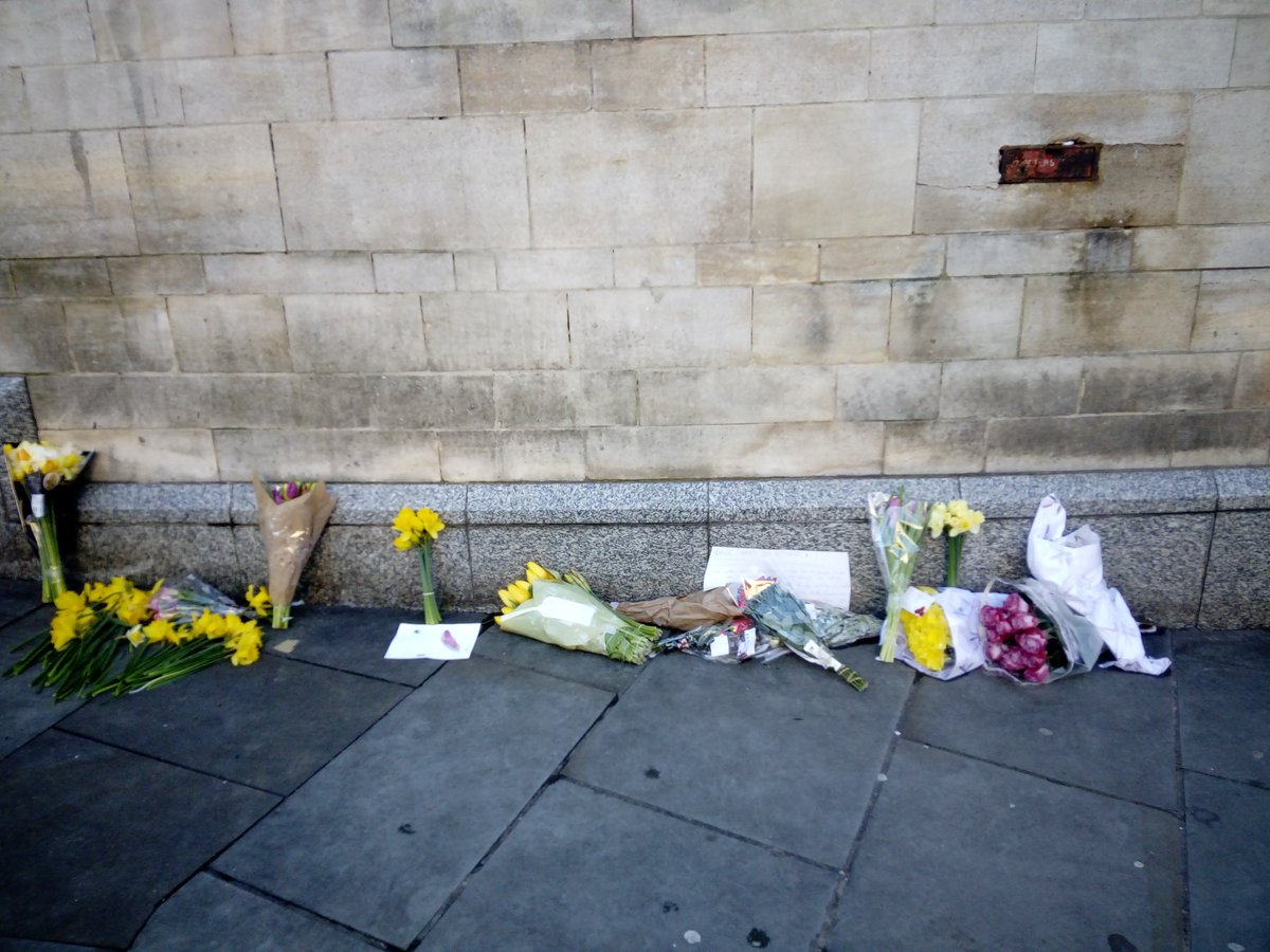 ash_tag8's tweet photo. The pitch where @BigIssue #vendor Dave stood selling the mags that helped get his troubled life back on track. On a grey &amp; dark week, some splashes of colour light up the walkway. #bigissue #RIP https://t.co/XADdD6GFRd