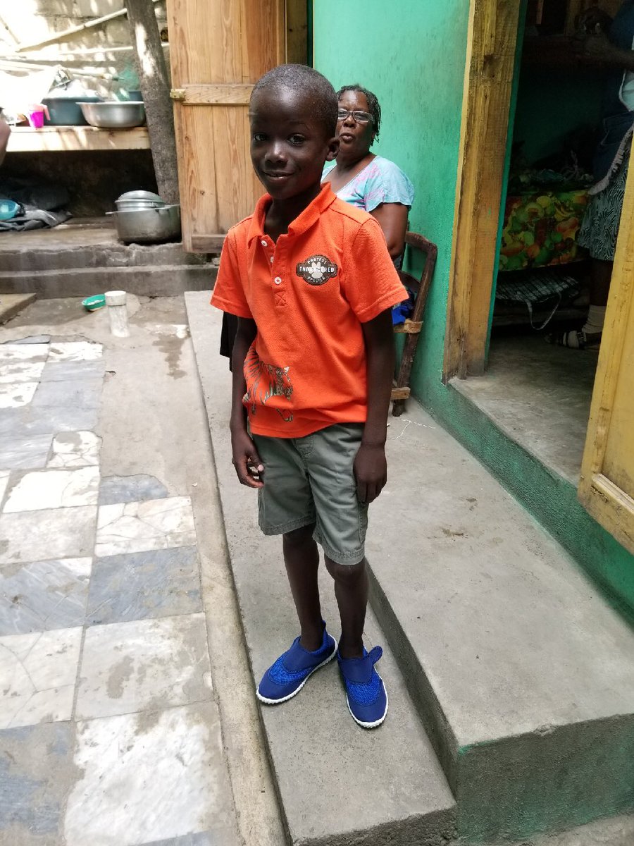 CoraaElizabethh's tweet photo. UPDATE: Dad found my boy Ti Rasta &amp; when he showed him my picture he yelled THATS CORA! Dad got him his new outfit &amp; shoes.. I can’t believe how much he’s grown in a year. My heart is oh so happy 🇭🇹❤️ https://t.co/jmRszPcAQU