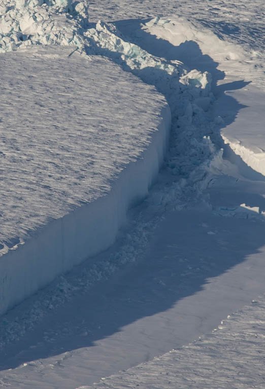 NASA_ICE's tweet photo. From today's #IceBridge flight: A close-up of a large crack in Petermann Glacier, northwest Greenland. https://t.co/6pmM1uAsdM https://t.co/5gYqBWSC4W
