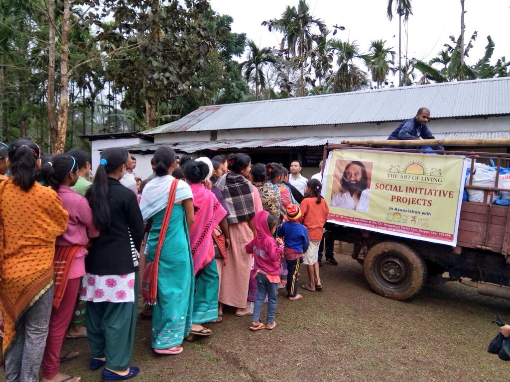Gurudev's tweet photo. .@ArtofLiving volunteers battled heavy rains and storms to distribute food and clothing to 400 tribal families scattered across the mountainous region of Rani, Assam, which gets cut off from the plains for 4 months during the monsoons. https://t.co/y2aiPZ08KC