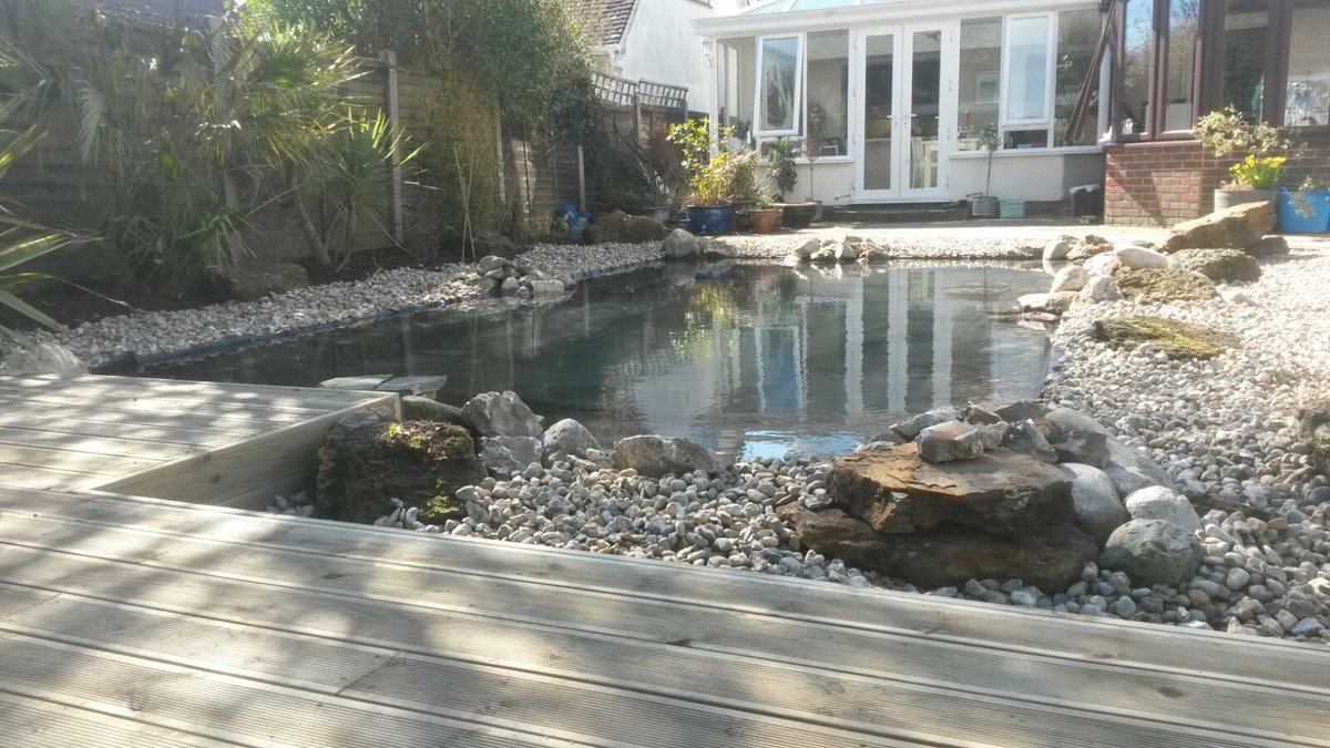 ShakespearesWS's tweet photo. Fully landscaped garden design and built by our team at Shakespeare's, featuring a large central pond framed by gravel and timber deck.  

#ponddesign #decking #timber #stone #gardendesign #landscapedesign #construction #westsussex https://t.co/iFFQzmSLFy