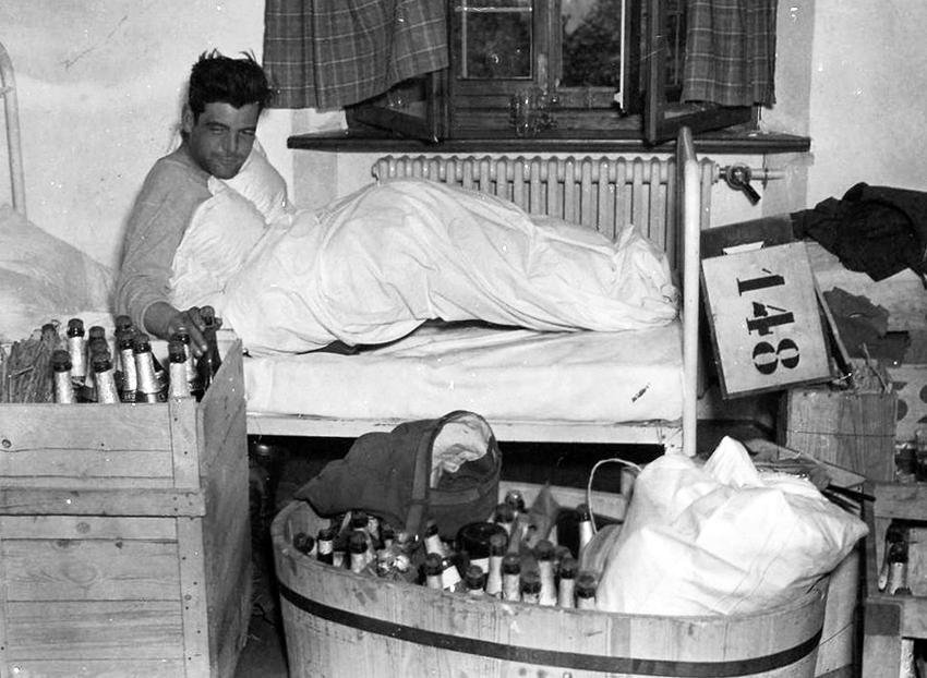 WWIIpix's tweet photo. Captain Lewis Nixon of Easy Company, 506th PIR, the morning after V-E Day. The booze comes from Hermann Göring's house. #WW2 https://t.co/DnoxkuRI3M