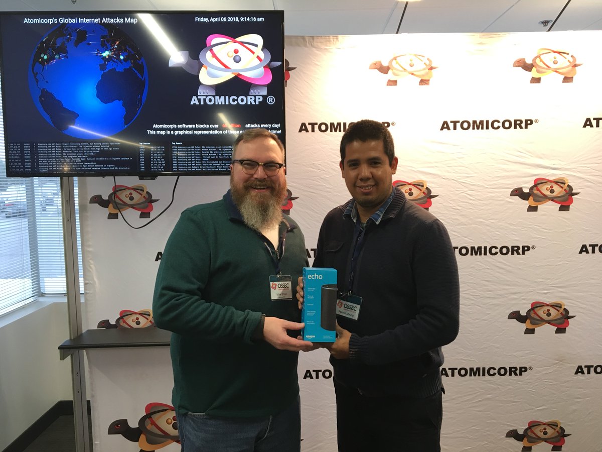 atomicorp's tweet photo. Renzo Aguirre came all the way from Peru to attend #OSSEC18 &amp; he was rewarded as the winner of the drawing. Here @mikegotroot gives him the prized #AmazonEcho. And, he learned a lot about #OSSEC too! https://t.co/0wHnMBv8o2