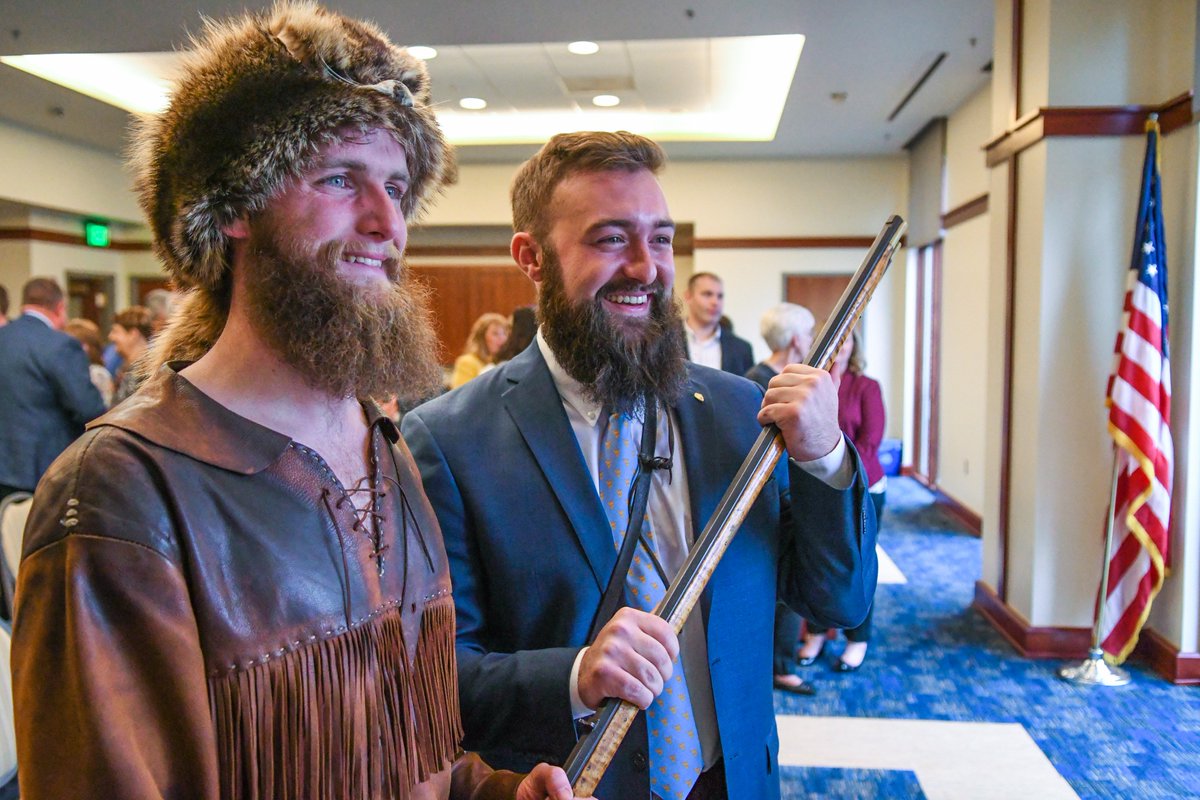 WestVirginiaU's tweet photo. The Passing of the Rifle 💛💙 Thanks for two years in the buckskins, Troy! Let's all welcome Trevor Kiess as the 65th Mountaineer Mascot! 👏👏👏 https://t.co/zpCEKnXZQ5