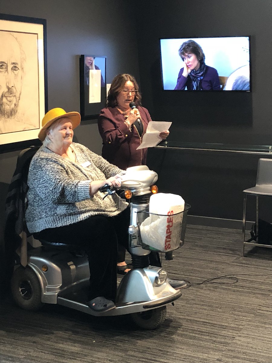 WaddingtonWMG's tweet photo. @noteworthi and @NewWestHospice first staffer Laura welcoming everyone to an amazing and powerful exhibit @anvilctr. Thanks to partner @ArtsCouncilNW !#lifetodeath #checkitout https://t.co/k5nGghZAqp