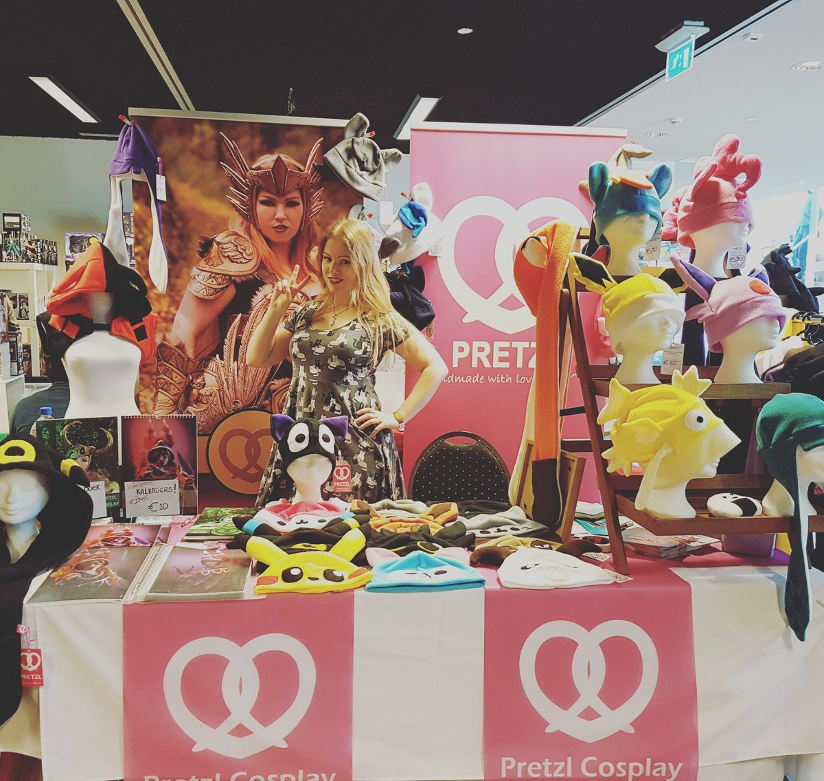 PretzlCosplay's tweet photo. All set up in the dealerroom at #Tomocon!!!! It's inside the building ^^ So come and find me!!!! I have hats, hoodies, prints, books and the last calendars! https://t.co/HwWlaJ0K0U