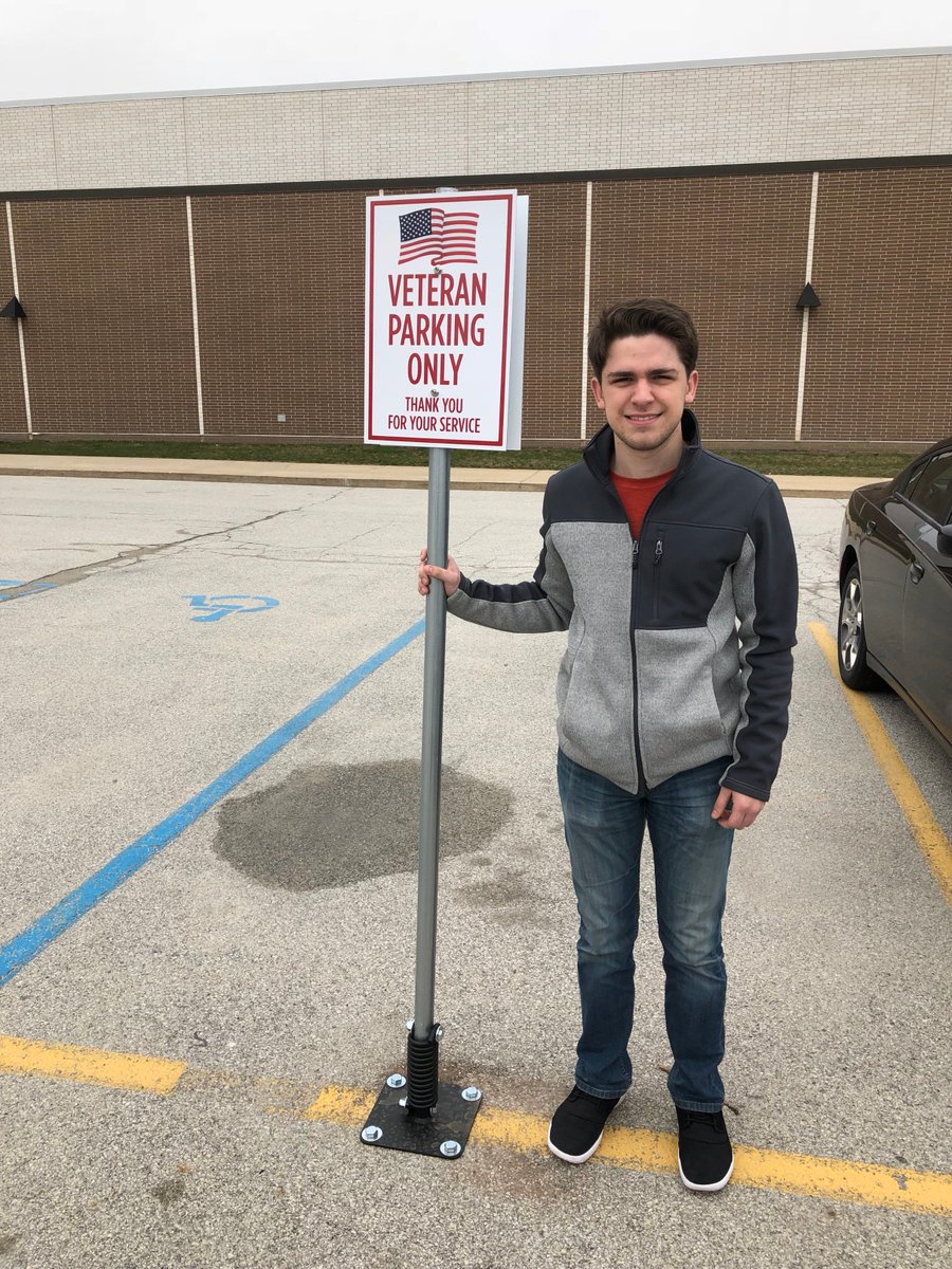 HNHSVikings's tweet photo. HNHS Senior Jake Fowler pictured with his capstone project.  Jake has created "Veteran Only" parking spaces for those who have served.  Great job, Jake! #HNVikingStrong https://t.co/UScwyz5M3L