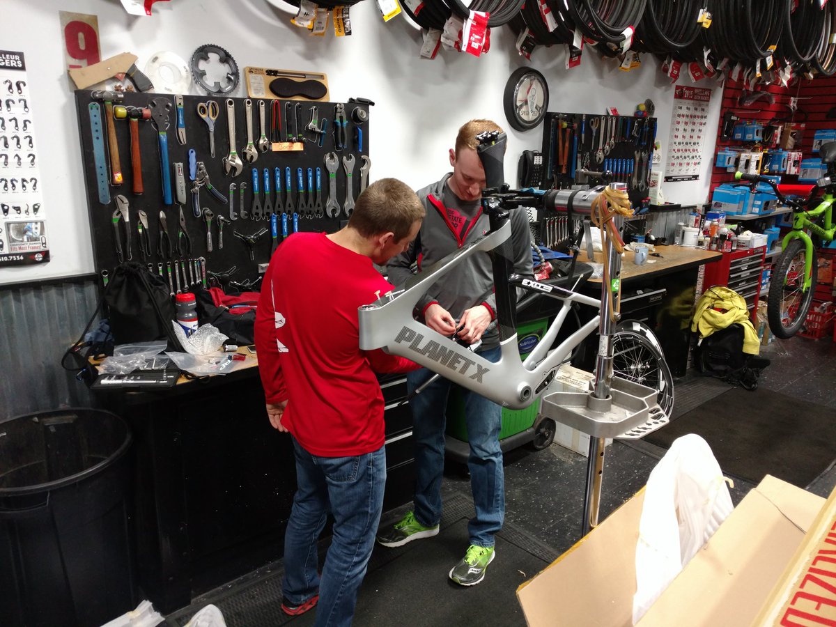OhioStateTri's tweet photo. Eric and Matt puzzling thru how to enable safe braking on this complex build. @usatriathlon Collegiate Nats prep. https://t.co/LlpG1fU8Ut