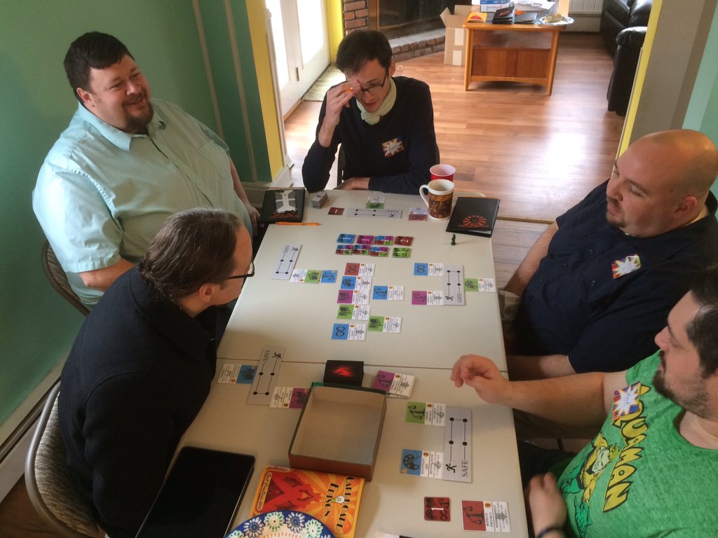 CardboardEdison's tweet photo. Finalist judging for the #CardboardEdisonAward is in full swing! On the table now: Dark Curios by @WorldsmithJim, The Library is Burning! by @apollocontinuum, and Hunker Chunky by @paperwilds! https://t.co/Zvsum3zL8e