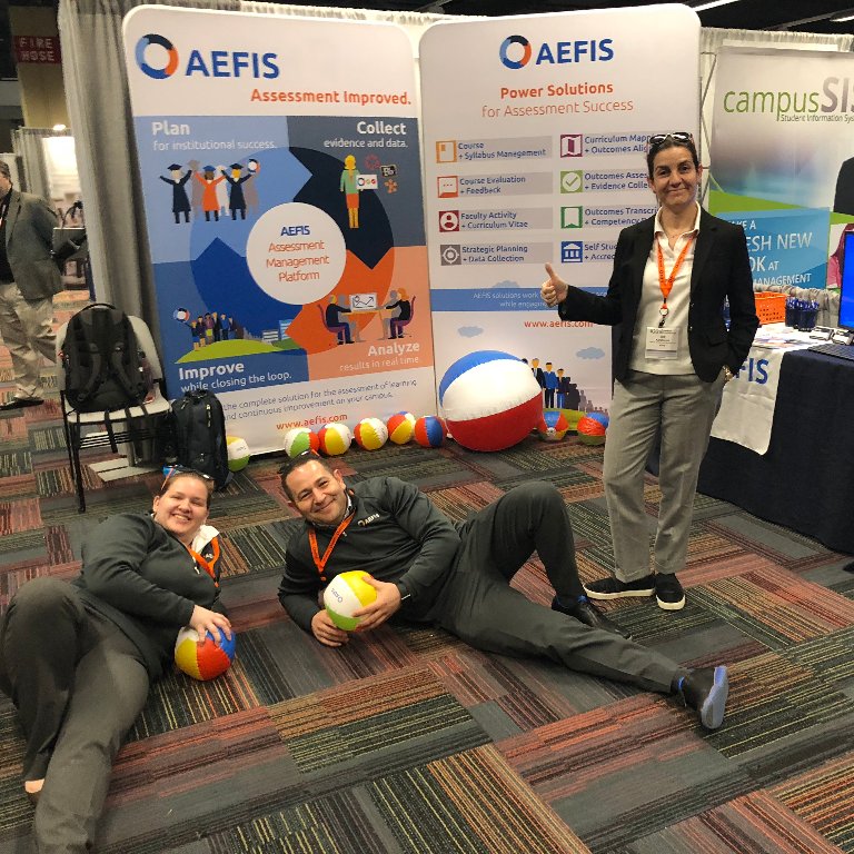 goAEFIS's tweet photo. It's day one at the #HLC2018 conference and the AEFIS team already threw a curve #ball! What's a conference without our CEO and interns goofing around and while Dee just #rolls with it. We can't wait to see everyone! #goaefis #assessmints #beachballs #highered #chicago https://t.co/ZSGmg649YN