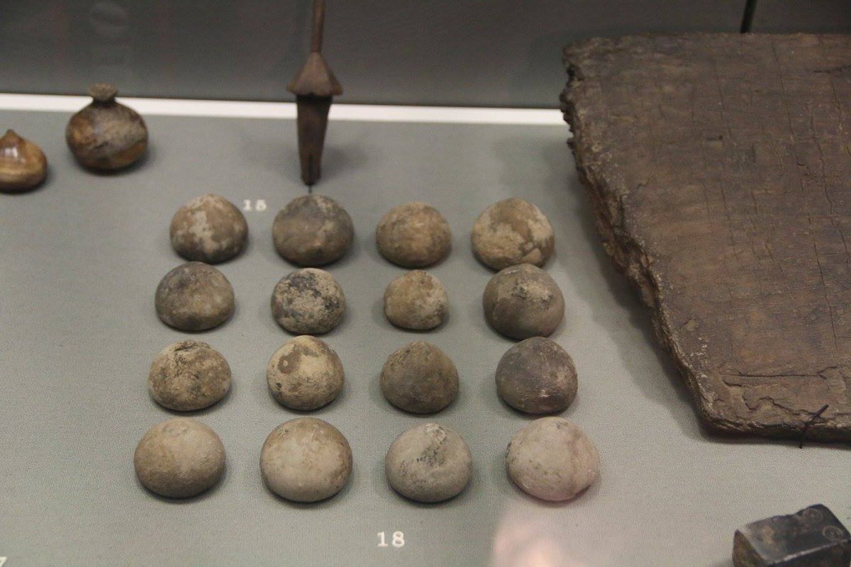 Viking era board game pieces in the National Museum of Archaeology, Dublin. To the right is a board with lines scratched on it. #Vikings #boardgames #History