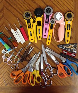 many scissors, cutters, and other quilting supplies